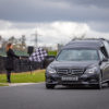 {
																																					A hearse on a racetrack with a chequered flag
																																			