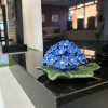 {
																																					A photograph of a display of ceramic flowers
																																			
