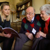 {
																																					Photograph of G. Seller employee discussing funeral plans with an elderly couple
																																			