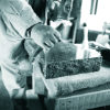 {
																																					A photograph of a memorial mason applying a chisel to a headstone
																																			